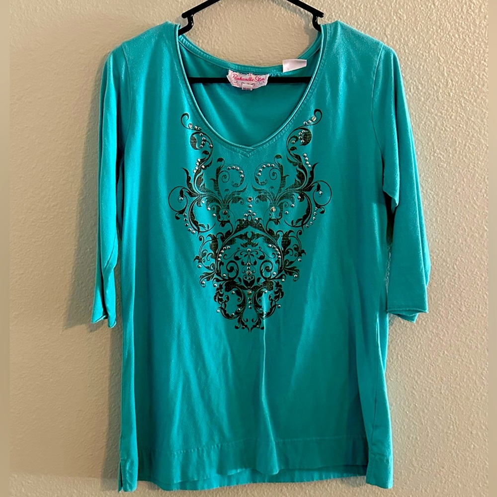 Beautiful blue southern shirt with jewels on front .